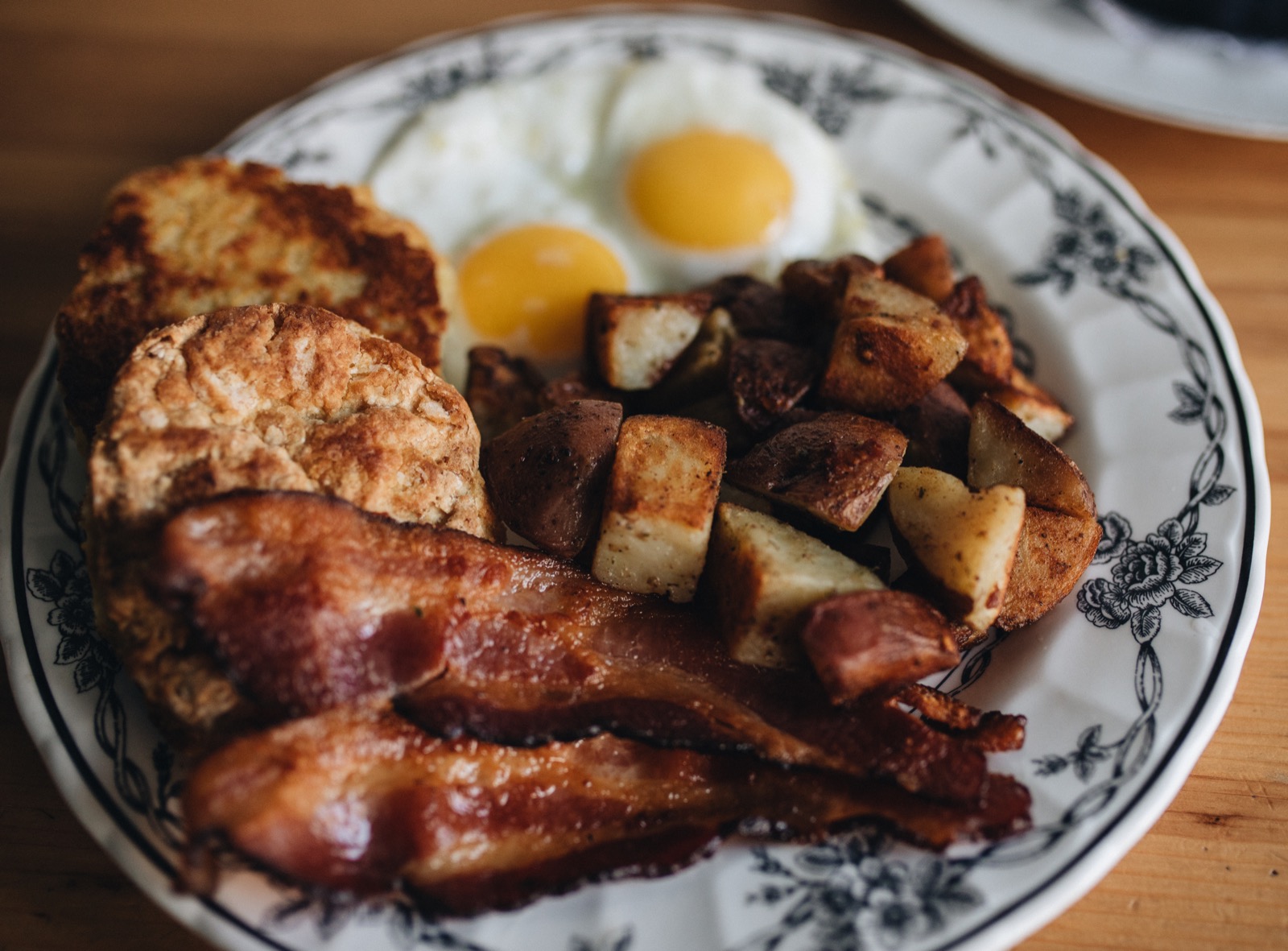 Breakfast plate with bacon eggs potatoes and biscuits at Little Griddle Cafe Portland